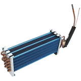 A blue and silver metal heat exchanger coil with copper pipes attached, standing on four short legs. One end has insulated copper tubing and a cylindrical component, making it an ideal Evaporator Coil for Empura Refrigeration systems. Plain white background.