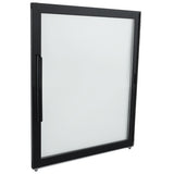 A rectangular, modern glass door (Left) with a black frame and vertical handle, from Empura Refrigeration, stands upright at a slight angle against a white background. The clear glass highlights the sleek Empura Parts design.