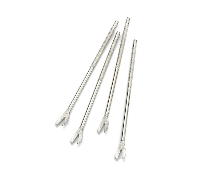 Four chrome plated corn holders are shown on a white background. Each features a textured grip and a forked, two-pronged end similar to shellfish forks. The holders are arranged diagonally and slightly overlap each other.
