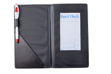 A TableCraft black bill holder folder is open, showing a red and white pen in a side loop and a blank blue guest check receipt on the right. The guest check has spaces for itemized orders, tax, and total, with "Guest Check" printed at the top.