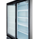 A commercial refrigerator with black trim and multiple empty white wire shelves inside. The interior is brightly lit, and the glass sliding door is partially open, revealing the clean, spacious storage area of this Empura ESM-50B refrigerated merchandiser.