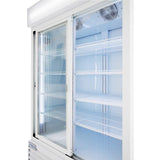 An Empura Refrigeration unit is shown open and empty, featuring two glass sliding doors. Inside, white wire shelves are evenly spaced beneath bright lighting with two cooling fans at the top, giving this refrigerated merchandiser a clean, modern look.