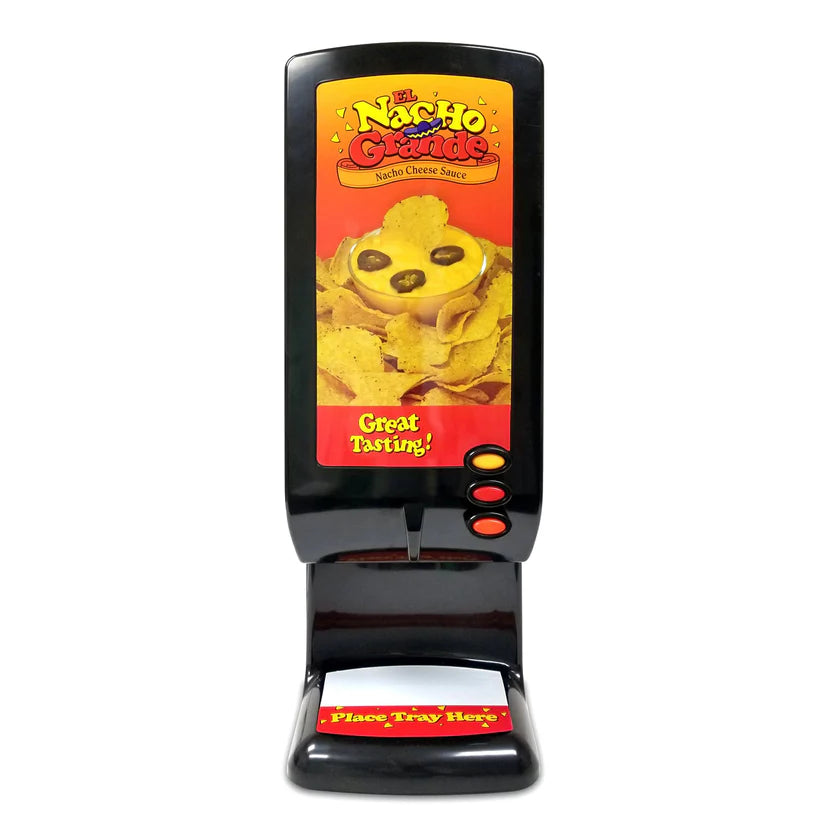 A black Nacho cheese dispenser labeled “El Nacho Grande Nacho Cheese Sauce” features nachos covered in cheese on the front. It uses a peristaltic pump for smooth serving and has three red buttons plus a tray marked “Place Tray Here” in yellow.