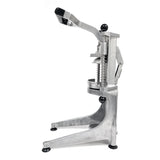 A manual aluminum Lemon Squeezer with a lever and sturdy base, featuring a handle and two vertical spring-loaded supports. Its circular holder beneath the pressing area and rubber feet provide stability for juicing fruits.