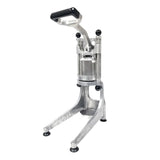 A silver and black manual press machine, similar to a Lemon Squeezer, stands upright on three rubber-tipped legs. Made of aluminum, it features a cylindrical chamber and a long, black-handled lever for pressing or crushing items within the chamber.