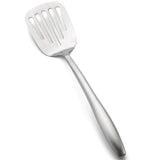 A stainless steel Dalton Collection Turner, this slotted turner features a wide, flat head with vertical slots for draining liquids. The angled utensil has an elongated handle and rests on a white background.