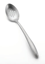 A stainless steel buffet spoon with a slightly rounded handle. This slotted buffet spoon features several narrow slots in the bowl for draining liquids from food. It is placed on a plain white background.
