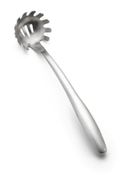 The Dalton Collection Pasta Grabber features a long handle and a rounded, slotted bowl with evenly spaced prongs for easy lifting and serving. This stainless steel pasta grabber is smooth, reflective, and dishwasher safe. Set against a white background.