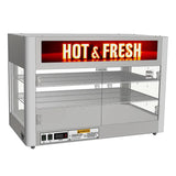 A Designer Holding Cabinet featuring durable stainless steel construction, this countertop food warmer offers two wire shelves, clear front and side panels, and a bold “HOT & FRESH” sign. Convenient controls and safety warnings are located on the lower front.