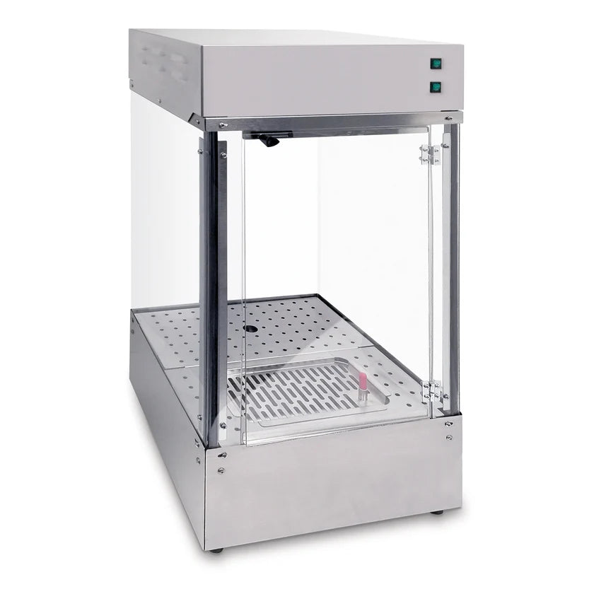 A stainless steel and glass countertop display cabinet with a vented metal base, two glass sides, a glass door, and two green power buttons on the top front panel. Inside, it features a perforated tray, heat lamps, and a red temperature indicator.