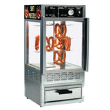 A stainless steel Humidified Merchandiser Cabinet with glass sides displays six hanging soft pretzels on metal rods. The top panel features controls, dials, and a “Soft Pretzels” sign, while a drawer below completes this clean, well-lit warmer.