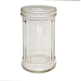A clear, empty 12 oz fluted glass jar with vertical ridges, wide mouth, and thick base. The words MADE IN are embossed near the bottom rim. The TableCraft Products jar is photographed against a white background.