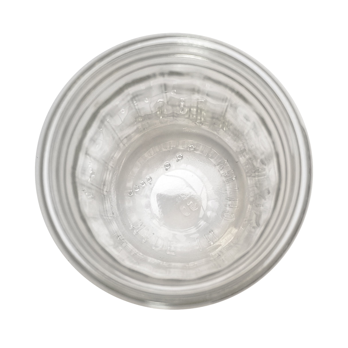 Top-down view of an empty 12 oz fluted glass jar by TableCraft Products against a white background. Ridged sides, circular opening, and embossed text are visible, with lighting emphasizing the jar’s transparency and reflections.