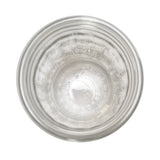 Top-down view of an empty 12 oz fluted glass jar by TableCraft Products against a white background. Ridged sides, circular opening, and embossed text are visible, with lighting emphasizing the jar’s transparency and reflections.
