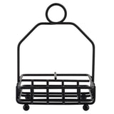 A black powder coated metal napkin holder with a rectangular base, grid design, four small round feet, and a tall handle featuring a circular ring at the top. This TableCraft Products piece is empty and photographed against a white background.