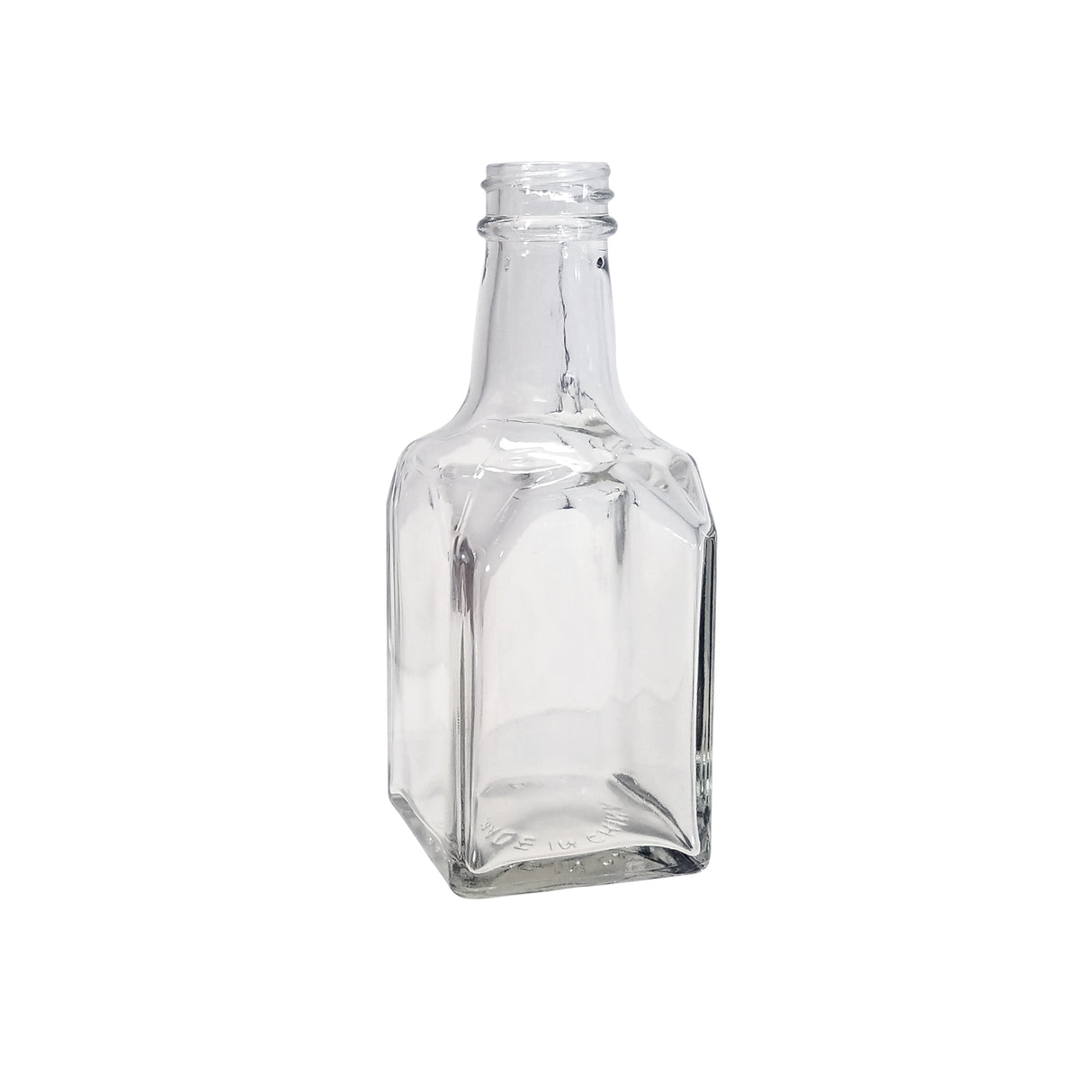 A clear, empty 6 oz. glass bottle with a square base, flat sides, and a short, narrow neck with threading for a cap. This dishwasher safe replacement jar stands upright on a white background.