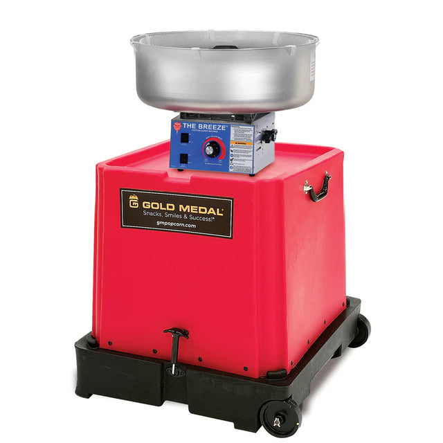 A commercial cotton candy machine with a large metal spinning bowl sits atop a bright red, box-shaped U-Tote-It base on wheels. The base features the Gold Medal Products logo, side handles, and a blue control panel with dials and labels.