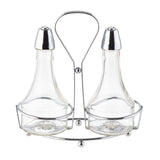 Two clear glass bottles with metal lids sit side by side in a shiny chrome plated rack with a handle. Designed as an Oil & Vinegar Dispenser, the elegant set features wide bases and narrow necks for easy pouring of your favorite liquids.