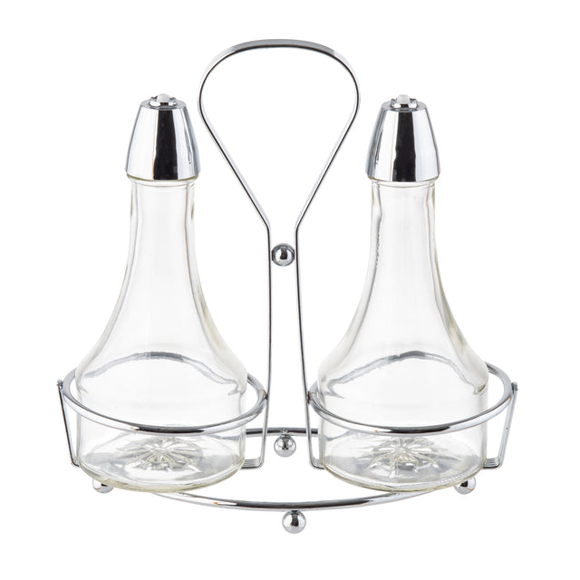 Two clear glass bottles with metal lids sit side by side in a shiny chrome plated rack with a handle. Designed as an Oil & Vinegar Dispenser, the elegant set features wide bases and narrow necks for easy pouring of your favorite liquids.