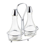 Two clear glass bottles with silver caps are held upright in a modern chrome plated rack with a looped handle. The Oil & Vinegar Dispenser set is empty, and the holder features round feet for stability and a sleek, contemporary design.