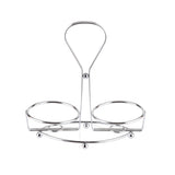 A TableCraft Oil & Vinegar Dispenser Rack, chrome plated with a central handle and two circular sections for bottles or jars. Its shiny, minimalist design features four round feet for stability, shown against a white background.