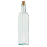 A tall, clear TableCraft olive oil bottle with a square base and slightly rounded shoulders, topped with a natural cork stopper. The empty bottle is set against a plain white background.
