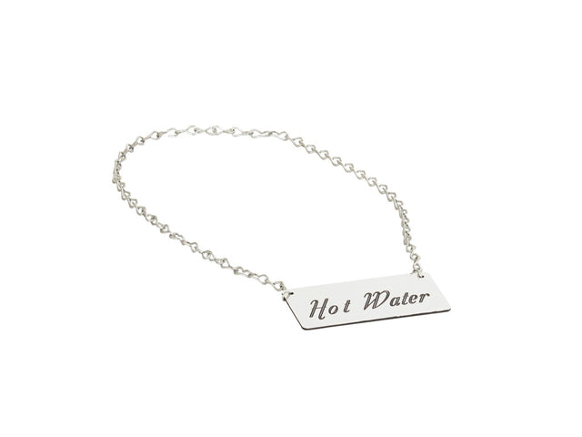 A silver chain with a rectangular metal tag attached. The tag, an Urn Sign by Cal-Mil, is engraved with the words Hot Water in a decorative script font. The background is plain white.