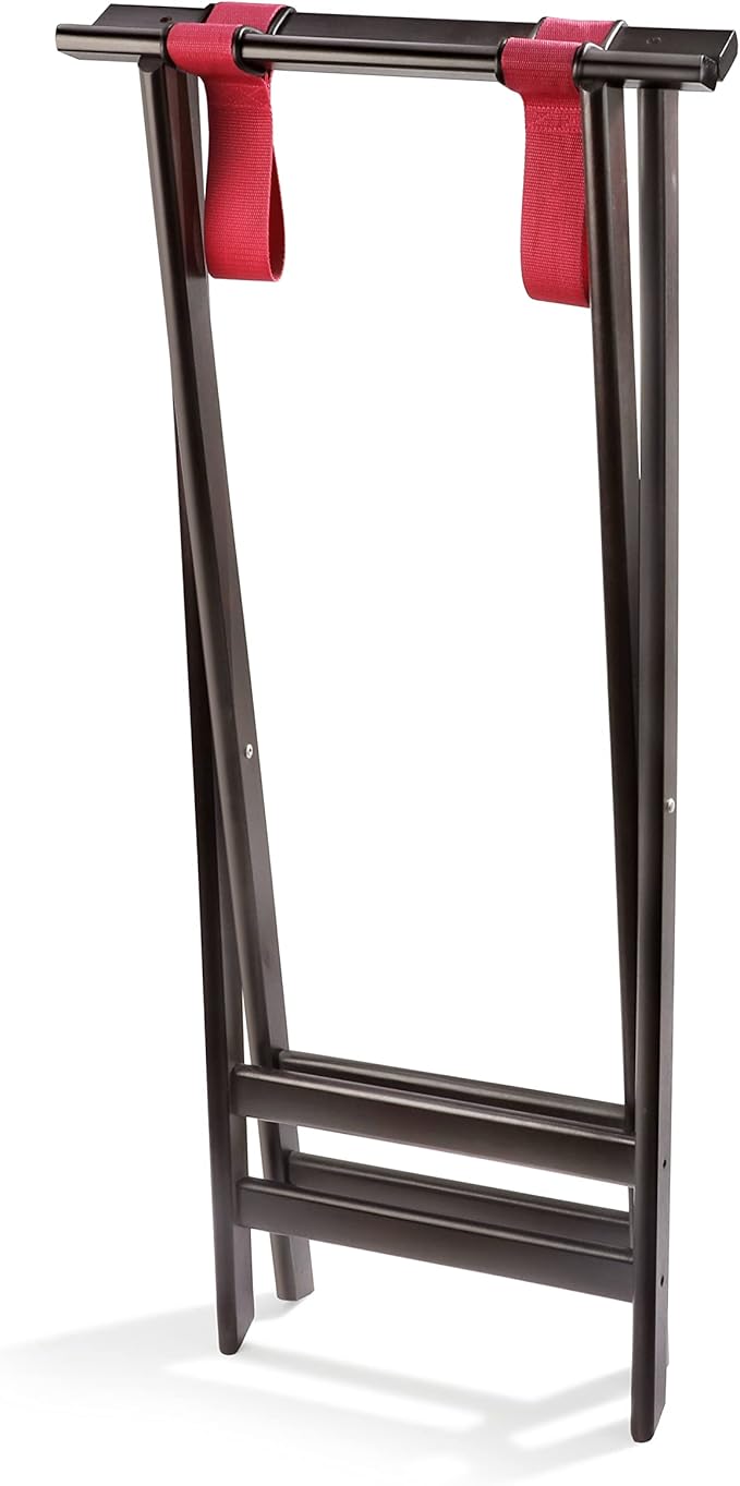A dark wood folding tray stand with a deluxe hardwood mahogany finish stands upright, featuring two parallel legs and two red fabric straps across the top for supporting a suitcase. The rack is simple and minimalistic in design.