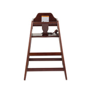 A dark wooden high chair, ASTM F404-18 compliant, with a safety strap, footrest, and warning label on the backrest. Viewed from the front against a white background, it features a classic design with an open front and angled legs.