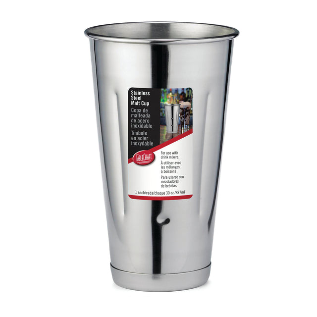 A shiny stainless steel malt cup with a wide top and tapered bottom. The front label displays text in English, Spanish, and French, a small photo of the cup in use, and the 30 oz (887 ml) capacity—all set against a white background.