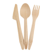 Three light-colored wooden 6-1/2" utensils from TableCraft Products—a serrated knife, spoon, and four-pronged fork—are arranged upright and slightly overlapping on a white background as part of this disposable utensil set.