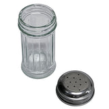 A clear, fluted glass salt/pepper shaker stands upright beside its round, stainless steel top with several holes for dispensing, both resting detached on a white background.