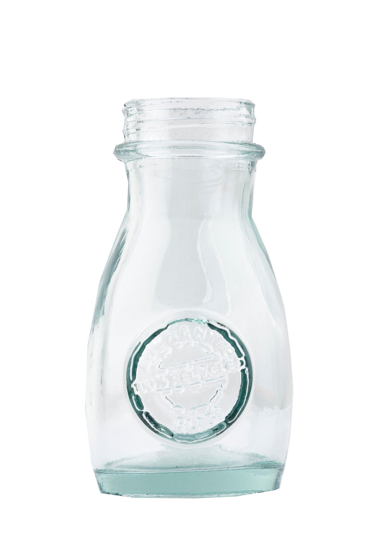 A clear, empty, vintage TableCraft 6618 glass milk bottle with a round embossed logo on the front. The bottle has a short neck, flared rim, and slightly curved sides. The plain white background emphasizes its transparent and clean appearance.