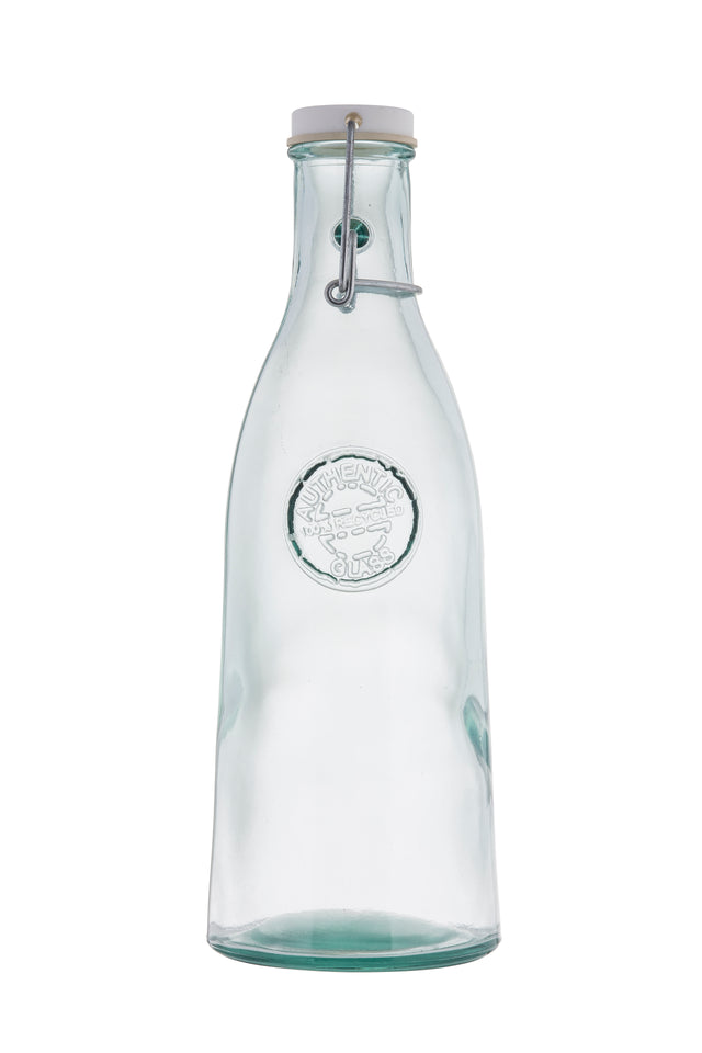A clear 33 oz bottle with a rounded body, embossed circular logo on the front, and a metal clasp securing a white stopper. This re-sealable bottle is empty and photographed against a plain white background.