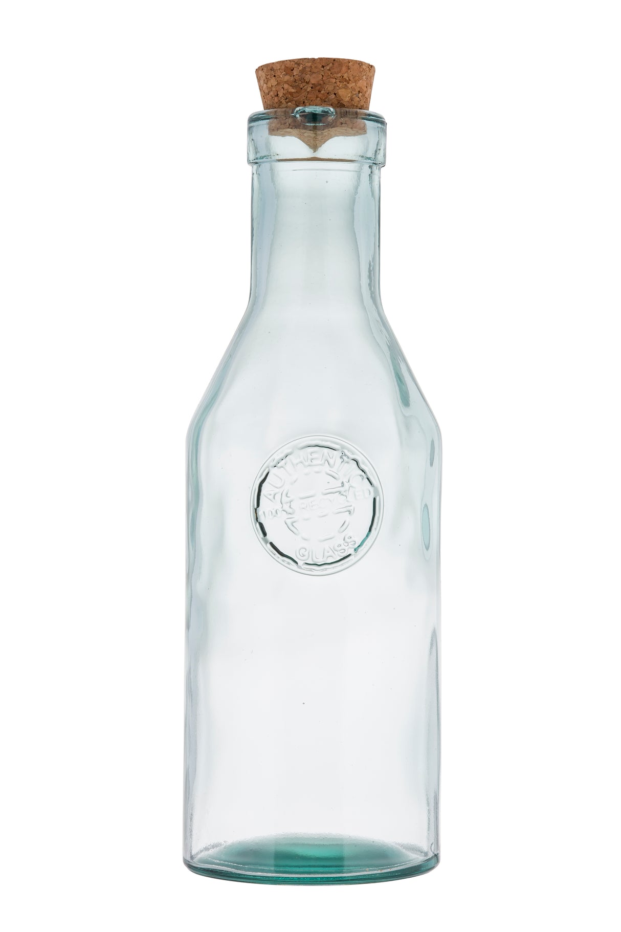 A clear apothecary bottle made of recycled glass features a round embossed seal on the front and is topped with a natural cork stopper. Its narrow neck widens at the base, set against a plain white background to highlight its simple design.