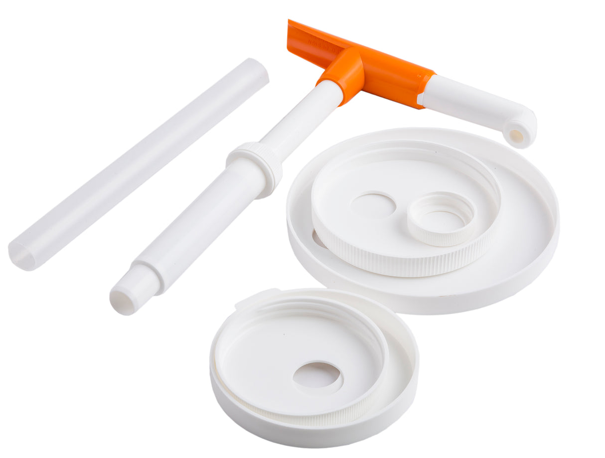 A set of dishwasher safe, white plastic components and lids with circular openings, plus a tool with an orange handle and white stem, are arranged on a white background. These items appear to be parts of a WideMouth Maxi Pump Kit.