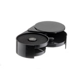 A black, circular rimmer bar tool with two swing-out trays; the left tray is open, revealing a sponge labeled LIME JUICE, while the right is shut with a solid lid. Dishwasher safe and placed on a white background.