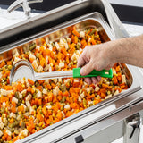 A hand uses a large Spoonout stainless steel ladle with a green handle to serve a colorful mix of vegetables from a tray, likely part of a buffet or cafeteria setup. The ladle is durable and dishwasher safe for easy cleaning.