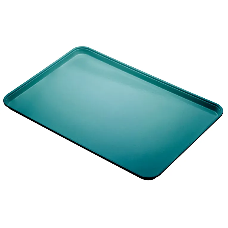 A rectangular, teal-colored Camlite Tray with slightly raised edges is shown at an angle against a white background. The smooth, dishwasher safe surface and rounded corners highlight its design for baking or roasting.