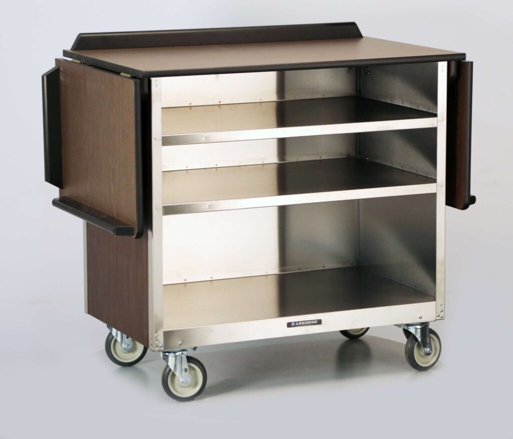 A stainless steel beverage service cart with three open shelves, brown wood side panels, large black handles on each end, and four caster wheels. The cart is empty and placed against a plain light background.