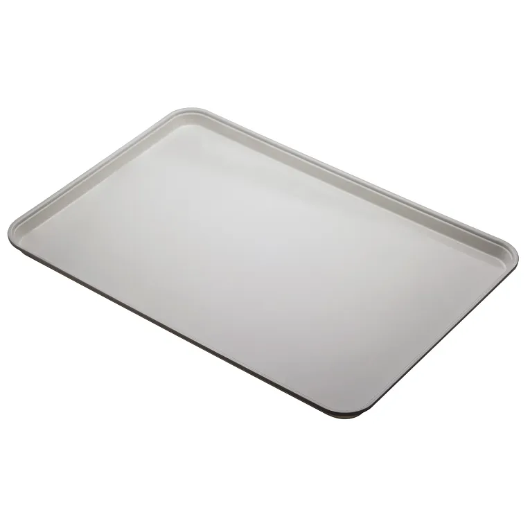 A plain, rectangular Camlite Tray with slightly raised edges is shown at an angle on a white background. The smooth, reflective surface highlights that this dishwasher safe tray appears empty and clean.