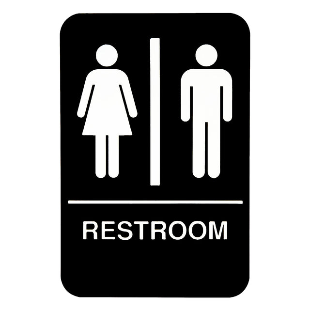 A black rectangular ADA compliant restroom sign features white icons: a female figure in a dress on the left, a male figure in pants on the right, separated by a vertical line. "RESTROOM" is written below in bold uppercase letters, with Braille included.