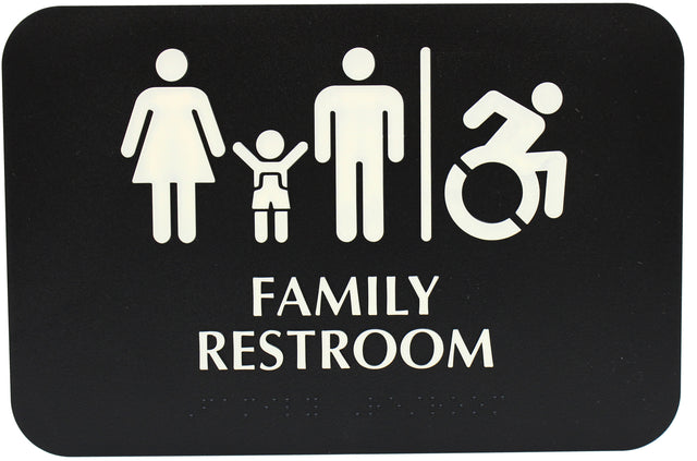 A black restroom sign with white icons of a woman, child, man, and wheelchair user separated by a line. Bold text reads FAMILY RESTROOM with ADA compliant Braille below, indicating the space is handicap accessible.