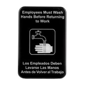 A bilingual restroom sign features a black background with white text and a hand washing icon. It reads, “Employees Must Wash Hands Before Returning to Work” in English and Spanish, reminding all with this clear hand washing sign.
