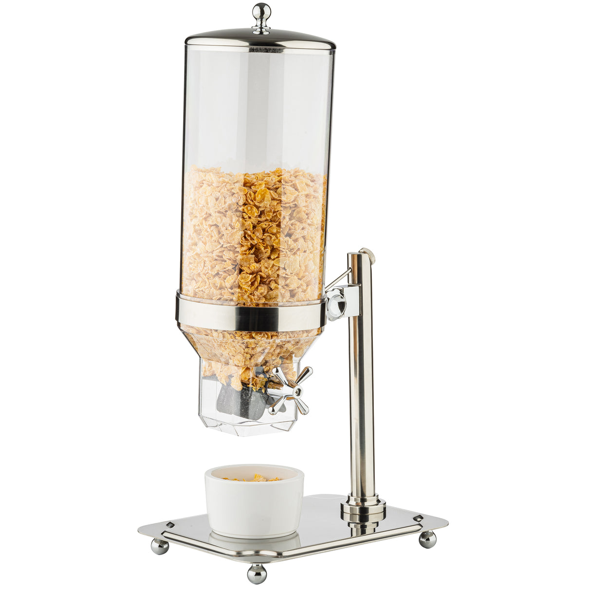 A tall, clear polycarbonate cereal dispenser with a stainless steel base and lid is filled with cornflakes. Below the dispenser, a white bowl with cornflakes sits on the reflective platform; all parts are dishwasher safe for easy cleaning.