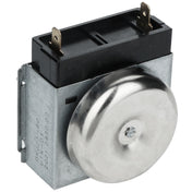 A close-up of an Empura Equipment oven timer with a silver metal housing and a round, shiny bell facing front. The black plastic top has two vertical brass prongs for electrical connections. Numbers and serial codes are printed on the metal side.