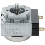 A close-up of a metal mechanical timer switch, compatible with Empura Equipment, features a central rotating shaft, black plastic housing, and two flat brass electrical connectors. The side displays printed text: DKJ/1-60 U1K-01 2021 0930 02.