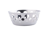 A round, stainless steel bowl with a smooth finish and variously sized circular cutouts around its sides, isolated on a white background. The bowl has a modern, decorative design and is dishwasher safe.