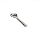 A small, stainless steel measuring spoon is centered on a plain white background. The spoon has a shallow, rounded bowl and a smooth, slightly curved handle with a shiny, reflective surface. This utensil is also dishwasher safe.