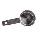 A stainless steel measuring cup marked “1/4 CUP 60 ml” is shown from above on a white background. The handle features a hole at the end, while the inside of this 1/4 cup displays a circular brushed metal pattern.